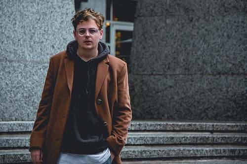 people man standing in front of gray concrete building person