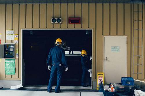 people man standing in front of open doorway person