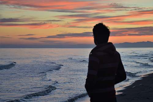 people man standing in front of seashore sea