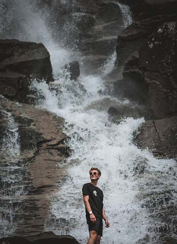 people man standing in front of waterfalls person