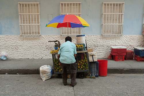 people man standing near car beside street person
