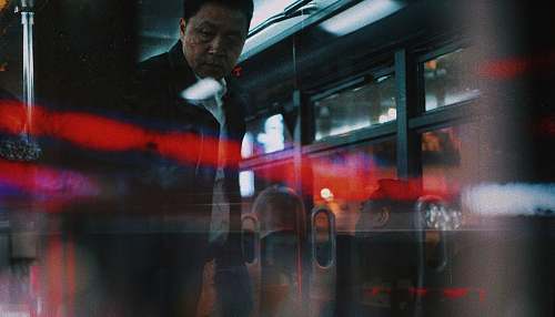 person man standing near glass door people