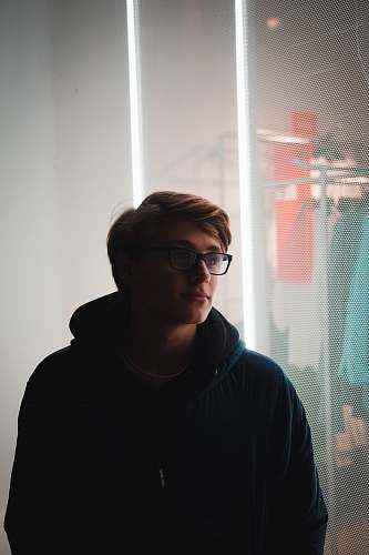 people man standing near glass window person