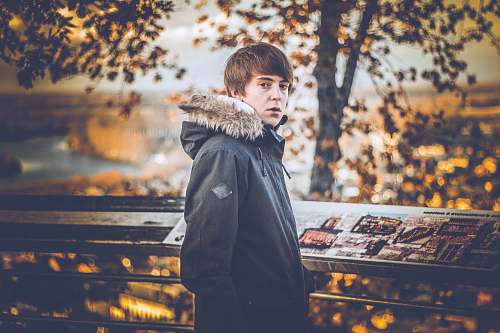 people man standing near trees during daytime person