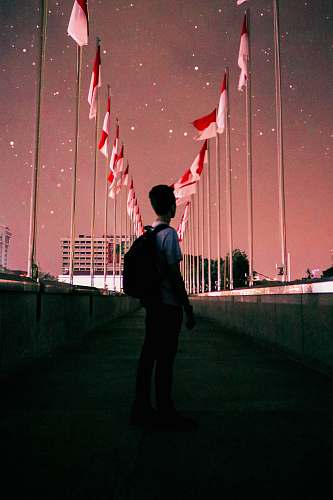 people man standing on bridge during night time person