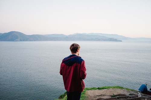 people man standing on cliff person