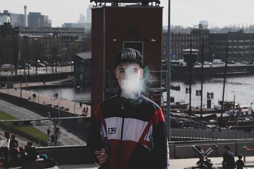 people man standing while smoking person
