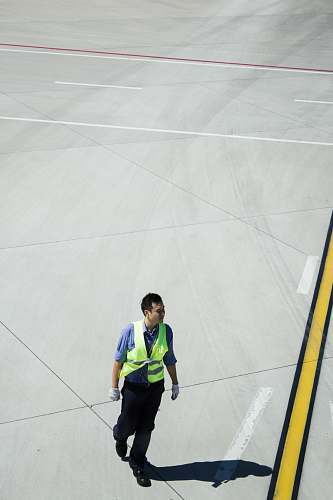 person man walking on concrete pavement people