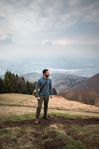 people man walking on mountain carrying bag person
