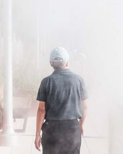 people man walking towards smoke-covered building person