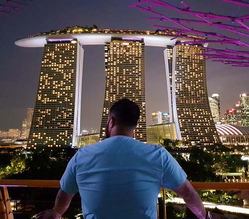people man watching high-rise buildings at nighttime person