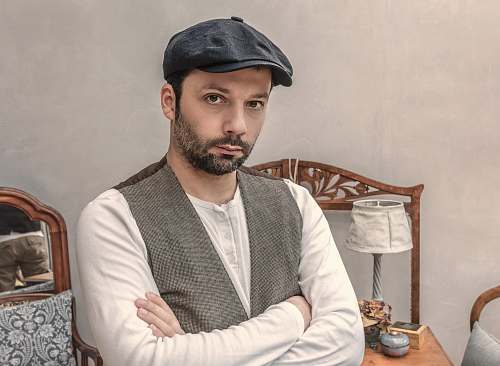 people man wearing gray vest near white table lamp person