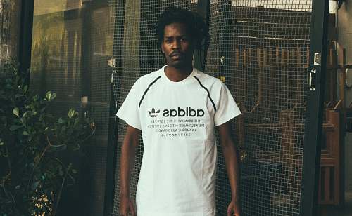 people man wearing white and black adidas crew-neck t-shirt person