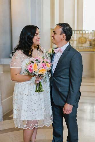 people married couple standing inside concrete building person