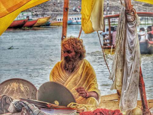person men's yellow traditional dress boat