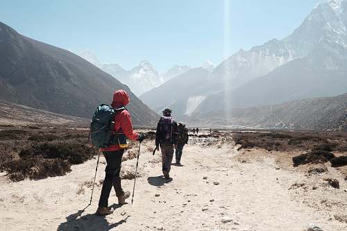 people people hiking towards mountain ranges hiking