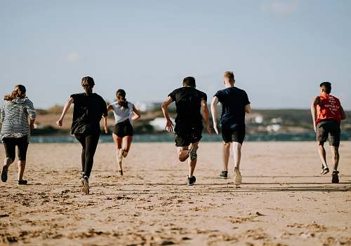 people people running on seashore person