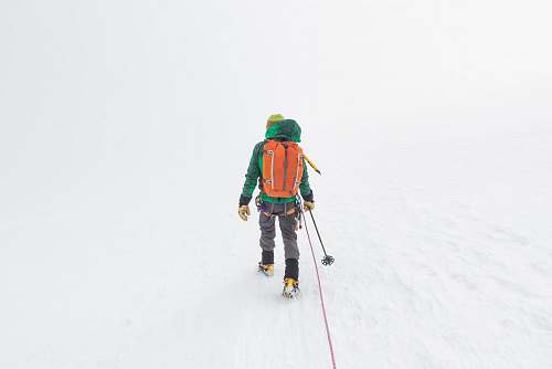 people person holding ski pole on snow covered atmosphere person