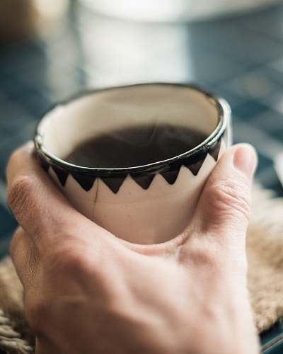 people person holding white ceramic teacup person