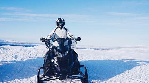 people person riding on snowmobile person