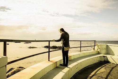 people person standing on building rooftop during daytime person