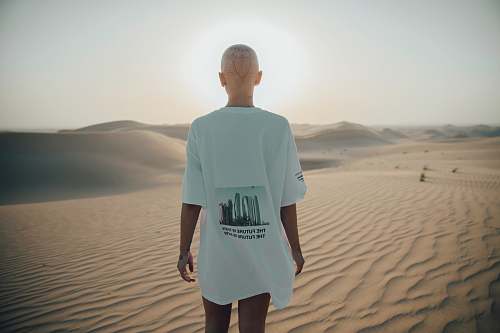people photography of woman standing on desert person