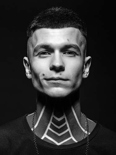 people portrait photography of man with neck tattoos black-and-white
