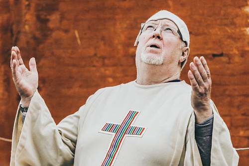 people priest standing near brown concrete wall person
