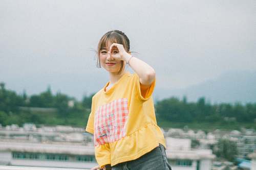 people selective focus photography of woman wearing beige crew neck t-shirt person