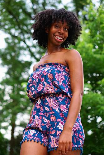 people selective focus photography woman wearing blue and pink floral tube rompers person