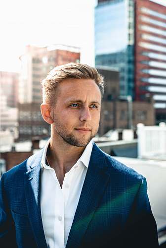 people shallow focus photo of man in black suit jacket person