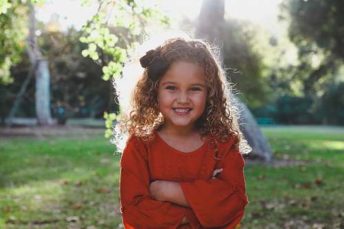 people shallow focus photography of girl in red long-sleeved top person