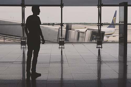 people silhouette of man on airport lounge person