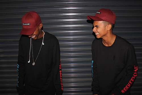 people smiling two men standing front of door shutter person