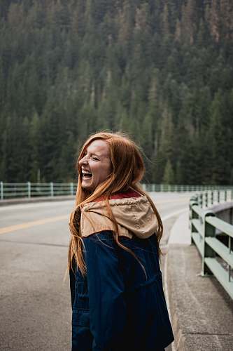 people smiling woman leaning on right on road person