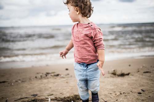 people toddler boy standing on seashore person