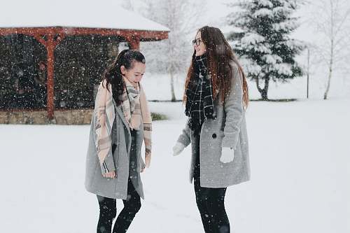 people two woman standing on snow field person