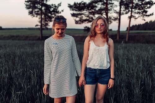 people two woman walking on grass land person