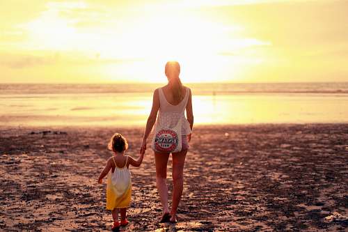 people woman and child facing towards sunset person