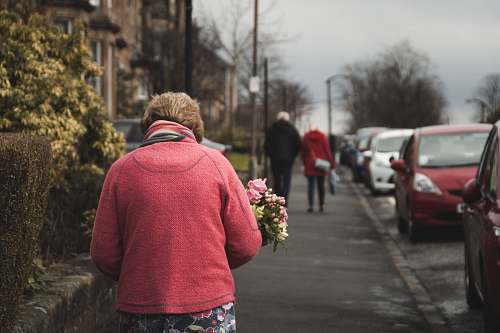 people woman carrying bouquet of flower white walking on street person