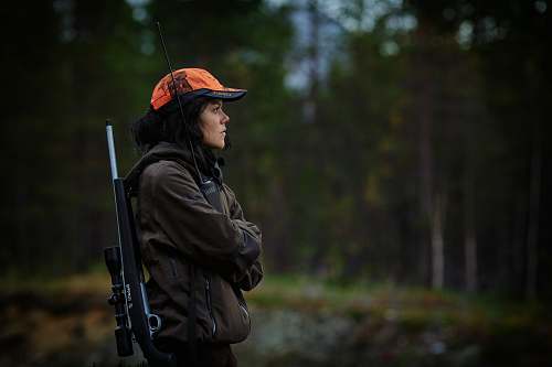 people woman carrying hunting rifle in woods person