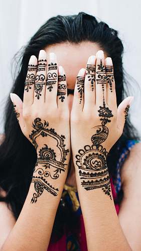 person woman covering her face with her two hands people
