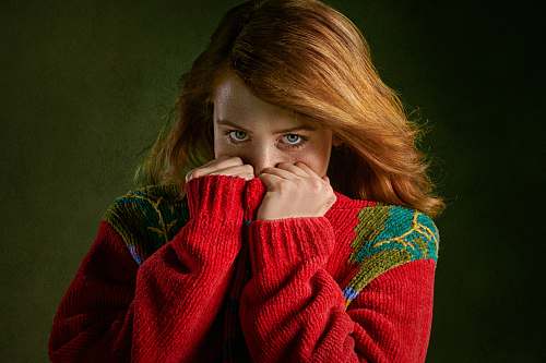 people woman covering mouth with sweater person
