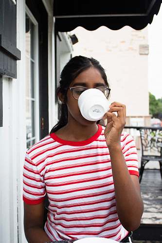 people woman drinking coffee outside house person
