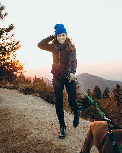 people woman holding green dog leash person