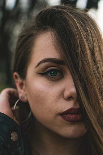 people woman holding hair at the back of her ear taking selfie person