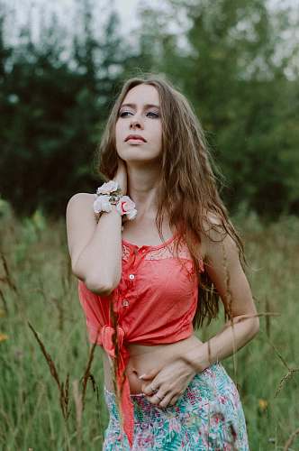 people woman holding her neck on grass field person