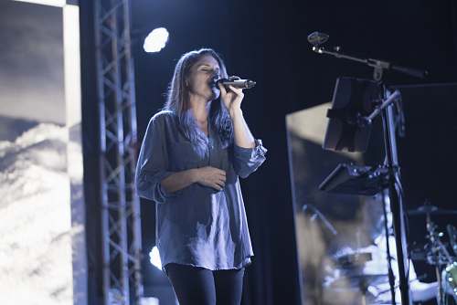 people woman holding microphone on stage person