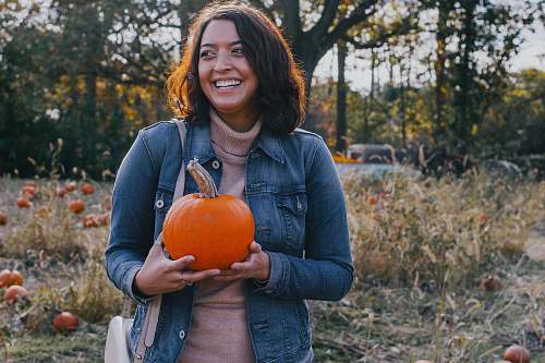 people woman holding pumpkin person