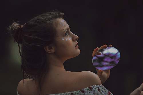 people woman holding round purple and black stone person